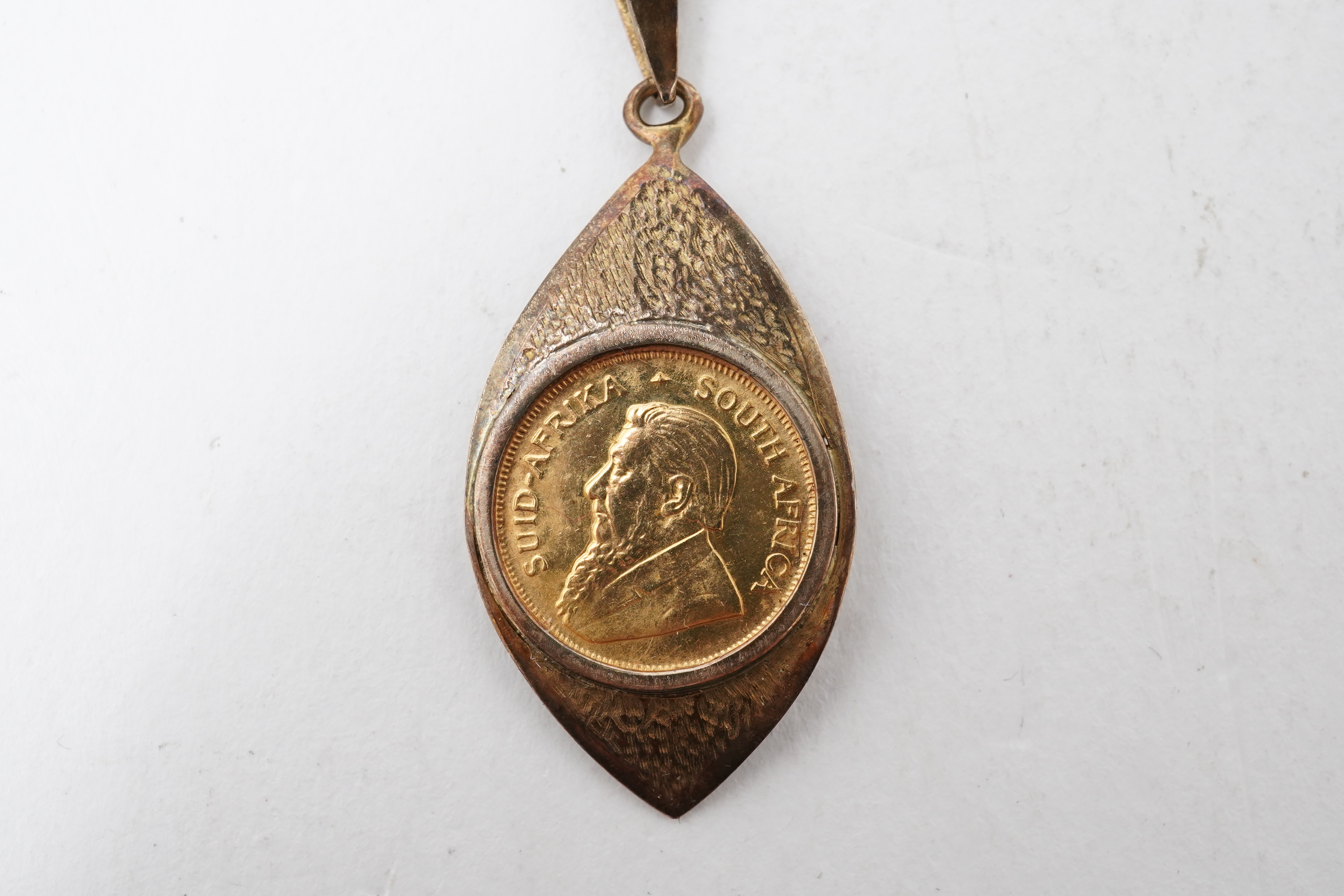A gold 1/10 Krugerrand coin necklace, circa 1988 and later